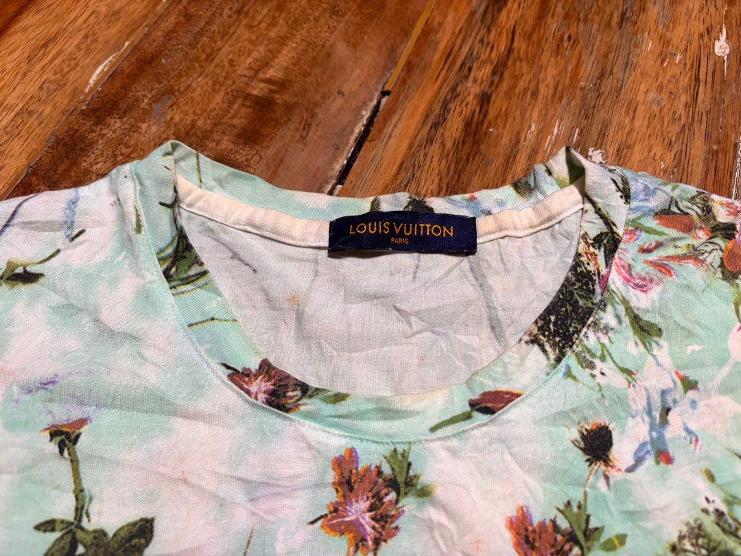 Louis Vuitton Paris Floral tshirt (Category: Tshirts & Polo Shirts ) located in Cagayan de Oro. Submitted by kirkwax_4 (Listing ID 1444418392, Image 2). Description: Louis Vuitton floral tee Small (19x25) In verygood/used condition Needs wash lng Light blue t-shirt with a vibrant all-over floral print. - Features bouquets of pink, purple, and white flowers with green leaves. - Prominently displays the Louis Vuitton Paris tag 680.