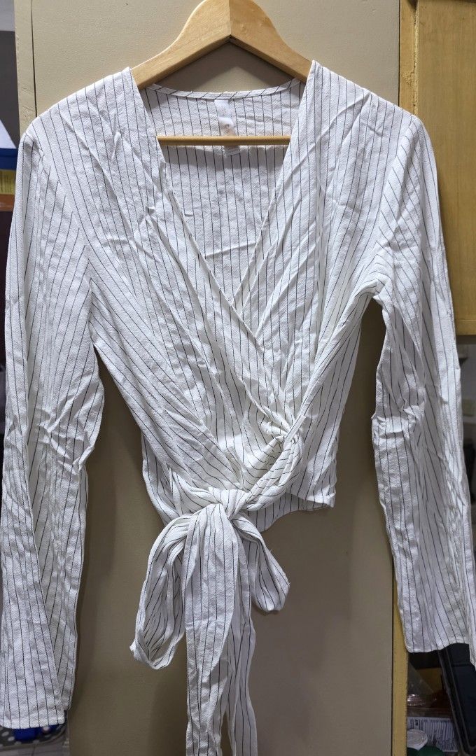 Mango long-sleeve wrap around blouse (Category: Blouses) located in Manila. Submitted by esamd (Listing ID 1444314751, Image 2). Description: Mango long-sleeve wrap around blouse Size: Medium RFS: decluttering Item was an impulse buy, never worn and was kept in the closet Location: Sampaloc, Manila near UST Shipping fee c/o buyer.