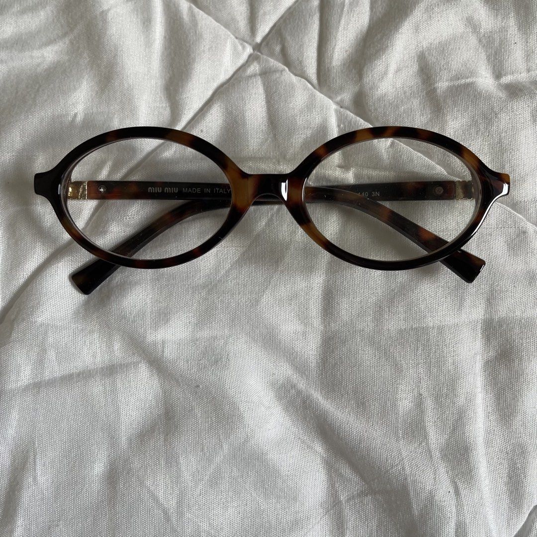 Miu Miu Tortoiseshell Oval Eyeglasses with Pouch (Category: Sunglasses & Eyewear) located in Batangas. Submitted by nathanielle_x (Listing ID 1444378744, Image 3). Description: - Miu Miu eyeglasses - Classic tortoiseshell pattern - Oval frame shape - Worn once - Comes with pink Miu Miu pouch - NOT authentic - Versatile for everyday wear or fashion statement - Please check photos for detailed condition.