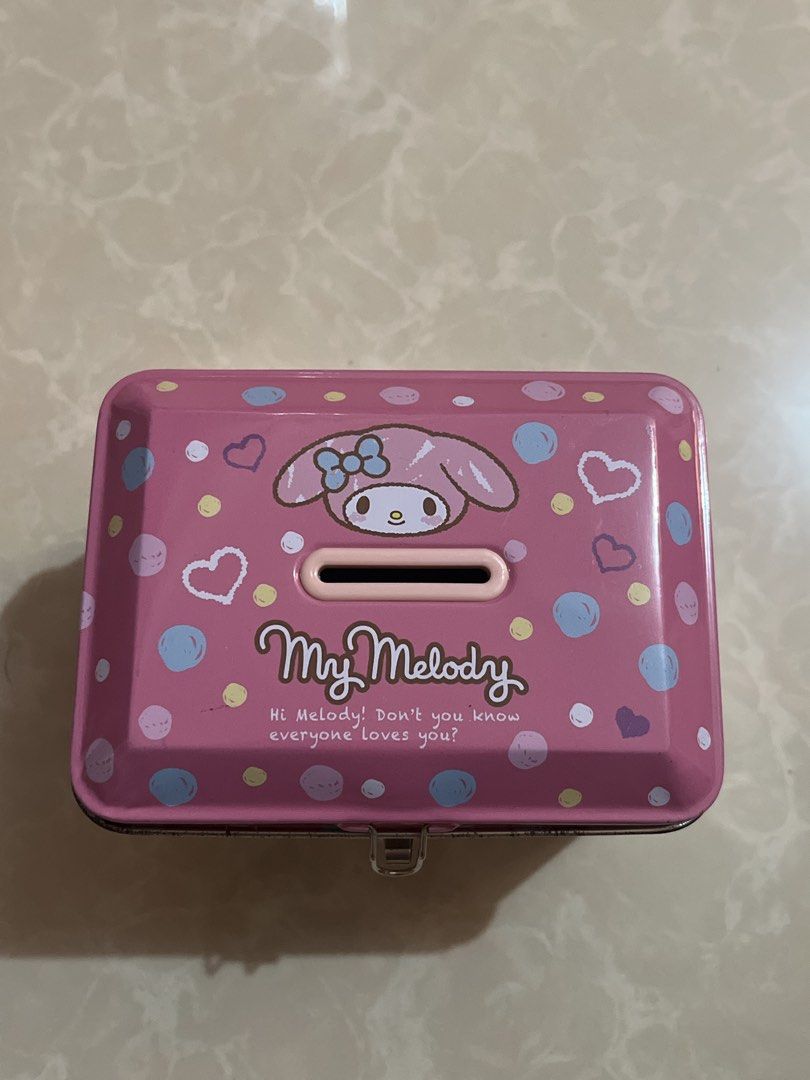 My Melody Pink Tin Box with Lock and Keys (Category: Storage Boxes & Baskets) located in Bay. Submitted by ronellie (Listing ID 1444331446, Image 2). Description: - Adorable pink tin box featuring My Melody - Features a coin/note slot on top - Comes with a small lock and 2 keys - Ideal for storing small treasures or as decor - A must-have for My Melody fans!.