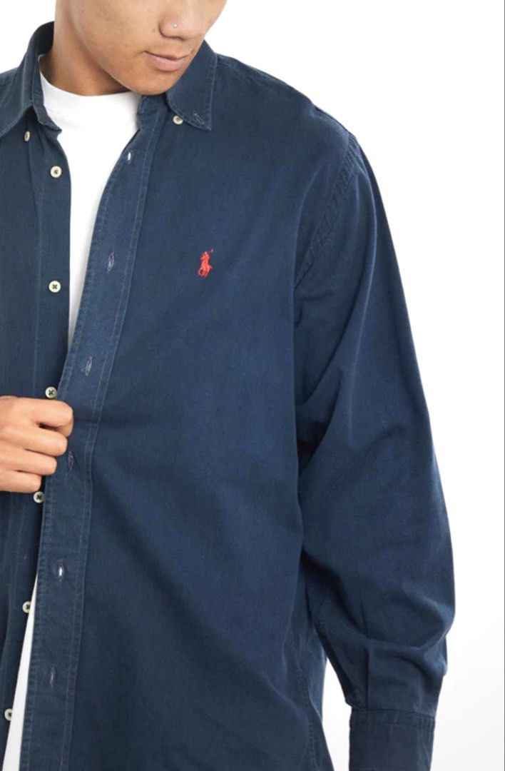 Navy Polo Ralph Lauren Button Up Shirt (Category: Tshirts & Polo Shirts ) located in Mandaue City. Submitted by kingtrix (Listing ID 1444356592, Image 2). Description: - Classic navy blue Polo Ralph Lauren button-up shirt - Iconic red pony logo embroidered on chest - Long sleeves with button cuffs - Perfect for dressing up or down - Easy to style for any occasion.