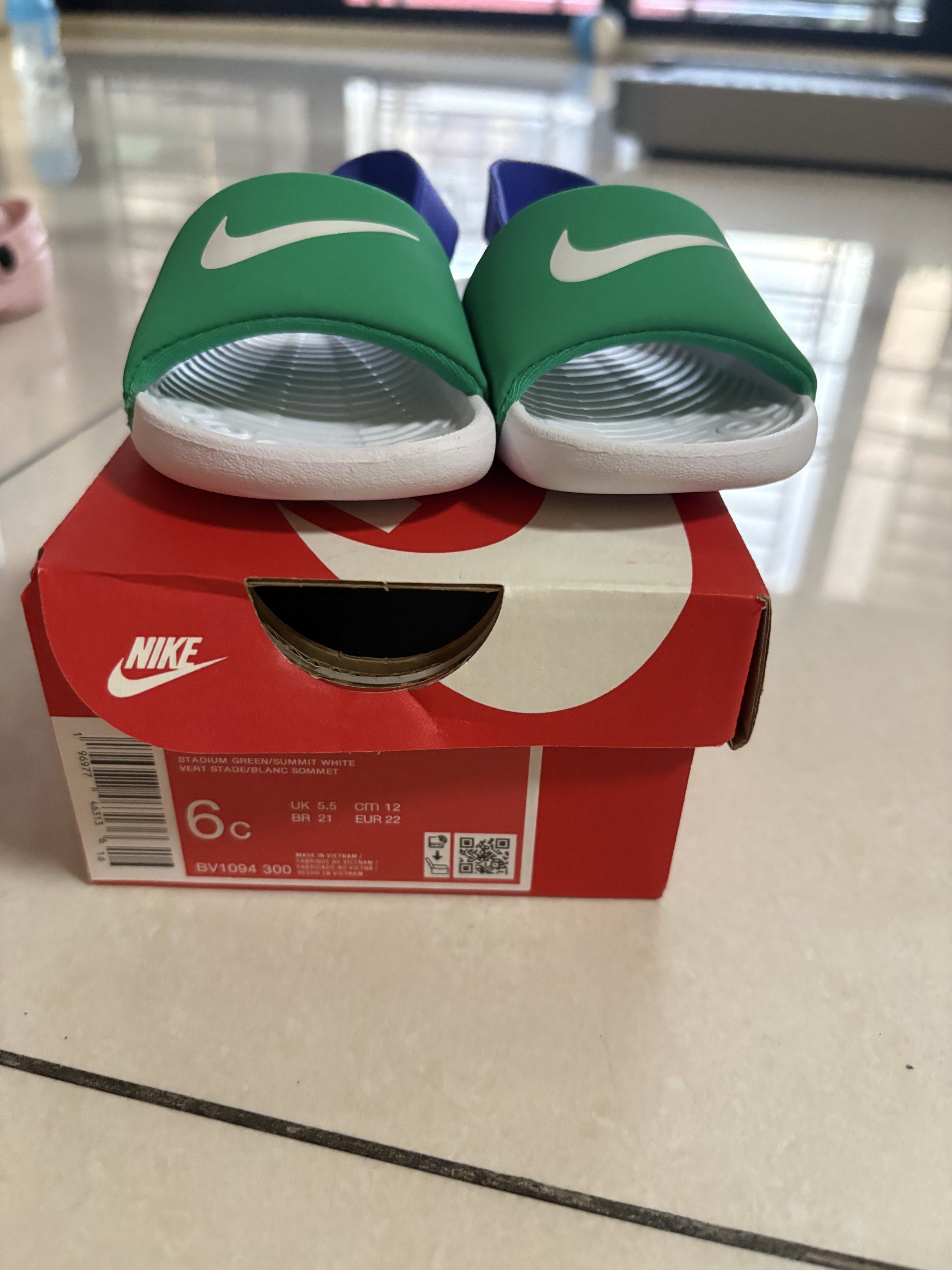 Nike Kids' Slides Green/White/Blue (Category: Babies & Kids Fashion) located in Quezon City. Submitted by jongph (Listing ID 1444454788, Image 2). Description: - Green Nike slides for kids - White Nike swoosh detail - Blue strap - Includes original box - Easy slip-on design - Ideal for beach and pool.