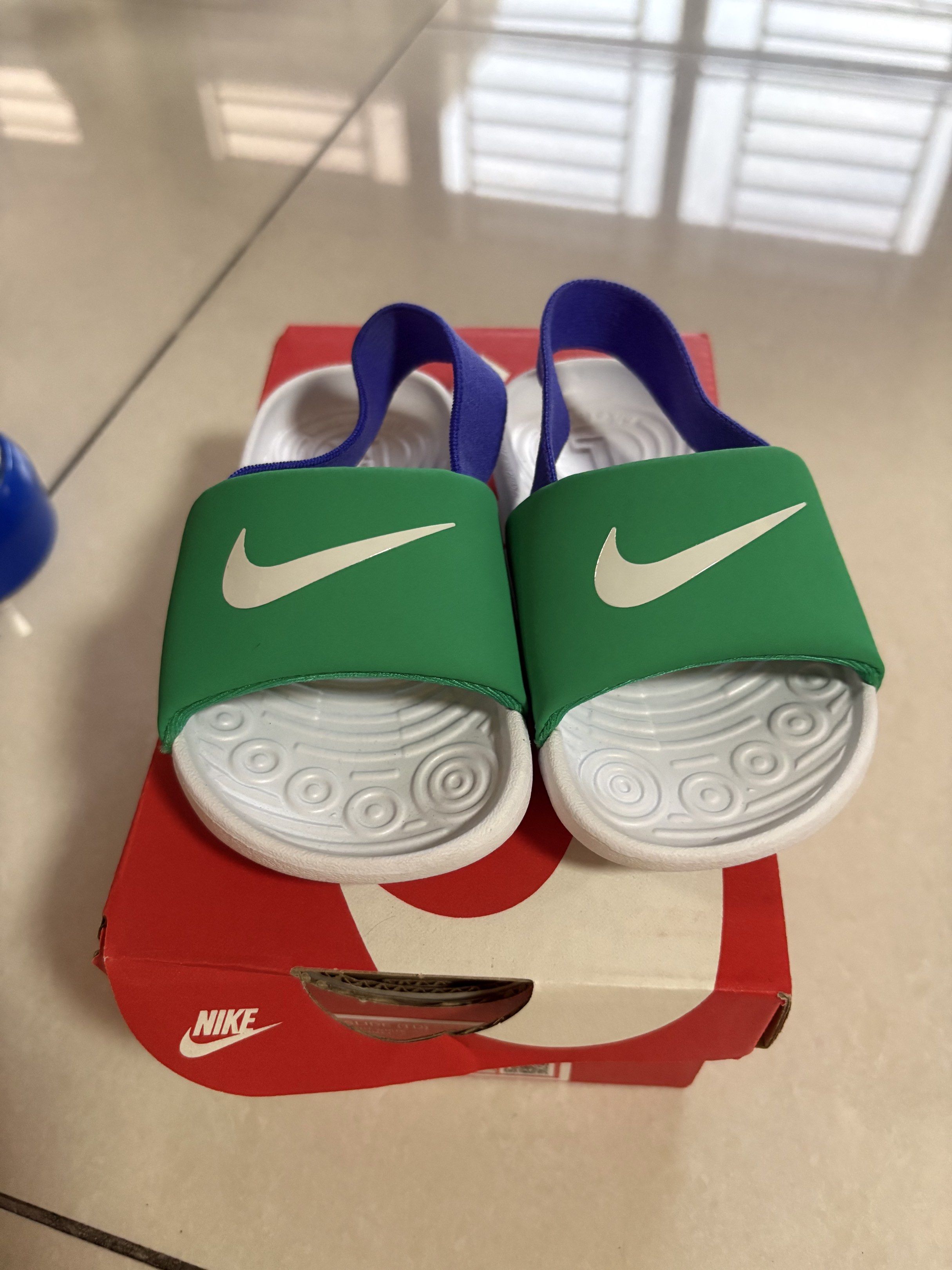 Nike Kids' Slides Green/White/Blue (Category: Babies & Kids Fashion) located in Quezon City. Submitted by jongph (Listing ID 1444454788, Image 1). Description: - Green Nike slides for kids - White Nike swoosh detail - Blue strap - Includes original box - Easy slip-on design - Ideal for beach and pool.