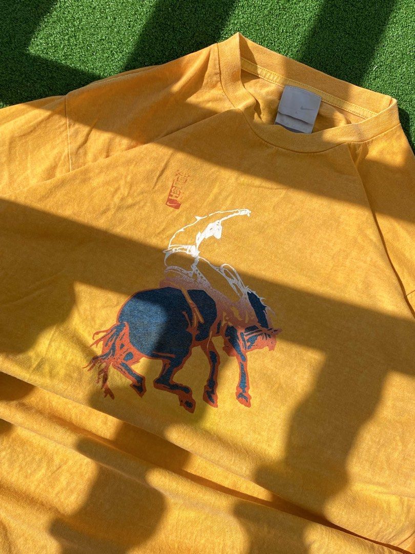 Nike Yellow Graphic T-Shirt (Category: Tshirts & Polo Shirts ) located in Batangas. Submitted by fezywez (Listing ID 1444350888, Image 3). Description: - Yellow Nike T-shirt - Size: Large (L) - Unique graphic print: Rider on a bucking horse - Origin: Made in Malaysia - Ideal for casual wear.