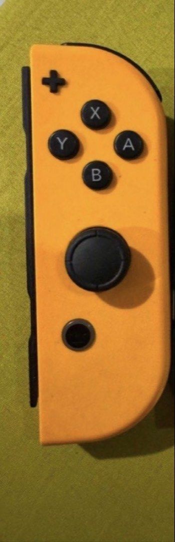 Nintendo Switch Orange Joy-Con (Right) (Category: Controllers) located in Imus. Submitted by chlouiepat (Listing ID 1444346500, Image 1). Description: - Orange Nintendo Switch Joy-Con controller - Left-hand controller - Black buttons and joystick - Fully functional, works great - Perfect for your next gaming adventure.