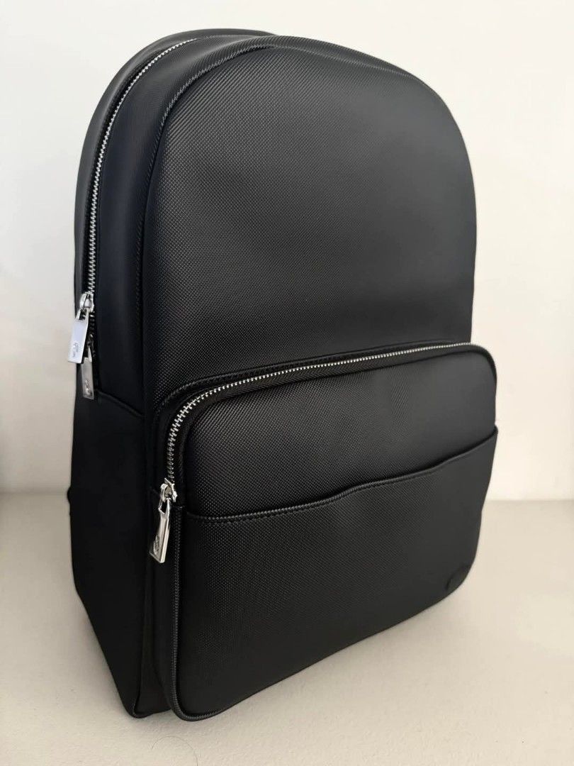 Original and Brand New Lacoste Men's Classic Backpack (Category: Backpacks) located in Pasig City. Submitted by pavy. (Listing ID 1444487366, Image 3). Description: Men's Classic Backpack Three exterior pockets including one zip pocket Interior: one computer pouch and three pockets including one zip pocket Tone-on-tone metal crocodile Dimensions 30 x 45 x 14 cm Exterior in petit piqué PVC.