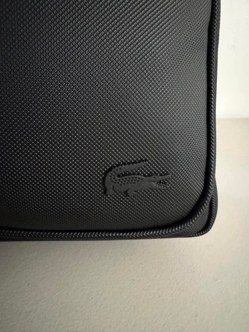 Original and Brand New Lacoste Men's Classic Backpack (Category: Backpacks) located in Pasig City. Submitted by pavy. (Listing ID 1444487366, Image 2). Description: Men's Classic Backpack Three exterior pockets including one zip pocket Interior: one computer pouch and three pockets including one zip pocket Tone-on-tone metal crocodile Dimensions 30 x 45 x 14 cm Exterior in petit piqué PVC.