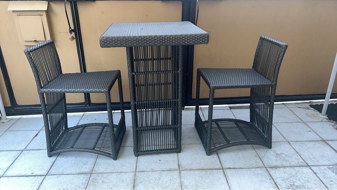 Outdoor Wicker Bar Table and 2 Stools Set (Category: Tables & Sets) located in Paranaque City. Submitted by dalumpines80725 (Listing ID 1444407504, Image 1). Description: - Dark grey outdoor bar set - Includes 1 tall table and 2 stools - Made of durable woven wicker material - Ideal for patio, balcony, or outdoor entertaining - Table features a stylish slatted design - Stools have matching woven seats and bases - Note: Minor wear on table top, pl