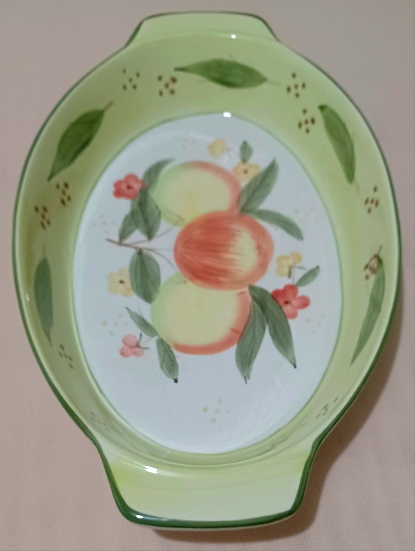 Oval Ceramic Dish with Fruit Design (Category: Bakeware) located in Quezon City. Submitted by wjmae (Listing ID 1444380077, Image 2). Description: - Oval ceramic baking dish - Hand-painted fruit and leaf design - Light green rim and handles - Ribbed exterior - Ideal for serving - Dimensions: Approx. 14 inches long x 9 inches wide.
