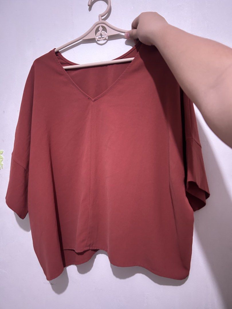 Oversized 2 Way V-Neck Round Neck Top - Rust Color (Category: Blouses) located in Las Pinas. Submitted by jesuswasborn (Listing ID 1444341730, Image 1). Description: - Loose-fitting V-neck top - Short sleeves - Hits around the hip - Beautiful rust color - Comfortable and breezy feel - Ideal for casual wear.