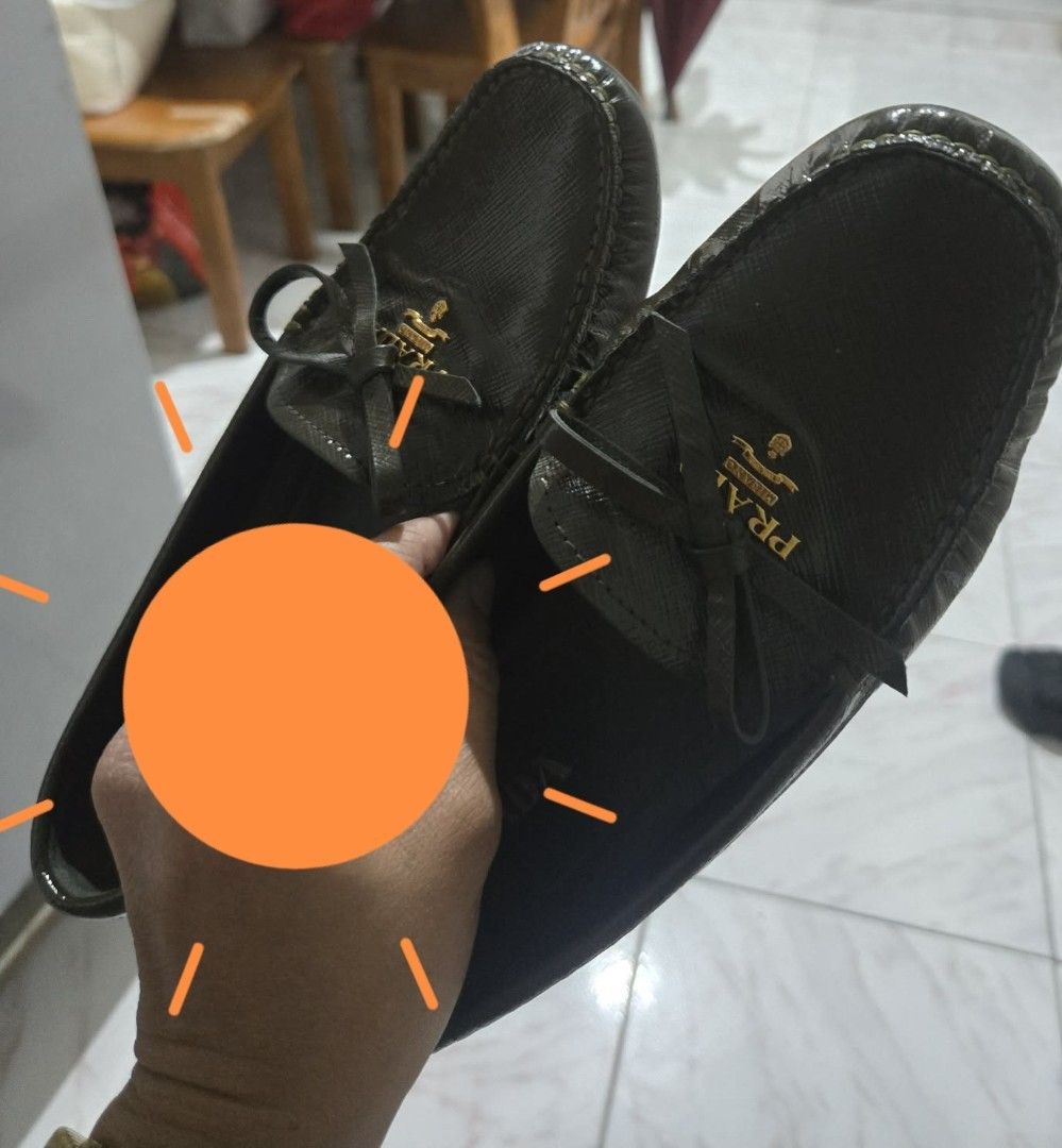 PRADA Black Leather Loafers with Bow Detail (Category: Loafers) located in Las Pinas. Submitted by peloveditems (Listing ID 1444372007, Image 3). Description: - Authentic Prada Loafers - Size: 36 - Color: Black - Material: Textured Leather - Features: Iconic Prada logo bow on front - Style: Comfortable slip-on - Includes: Original dust bag.