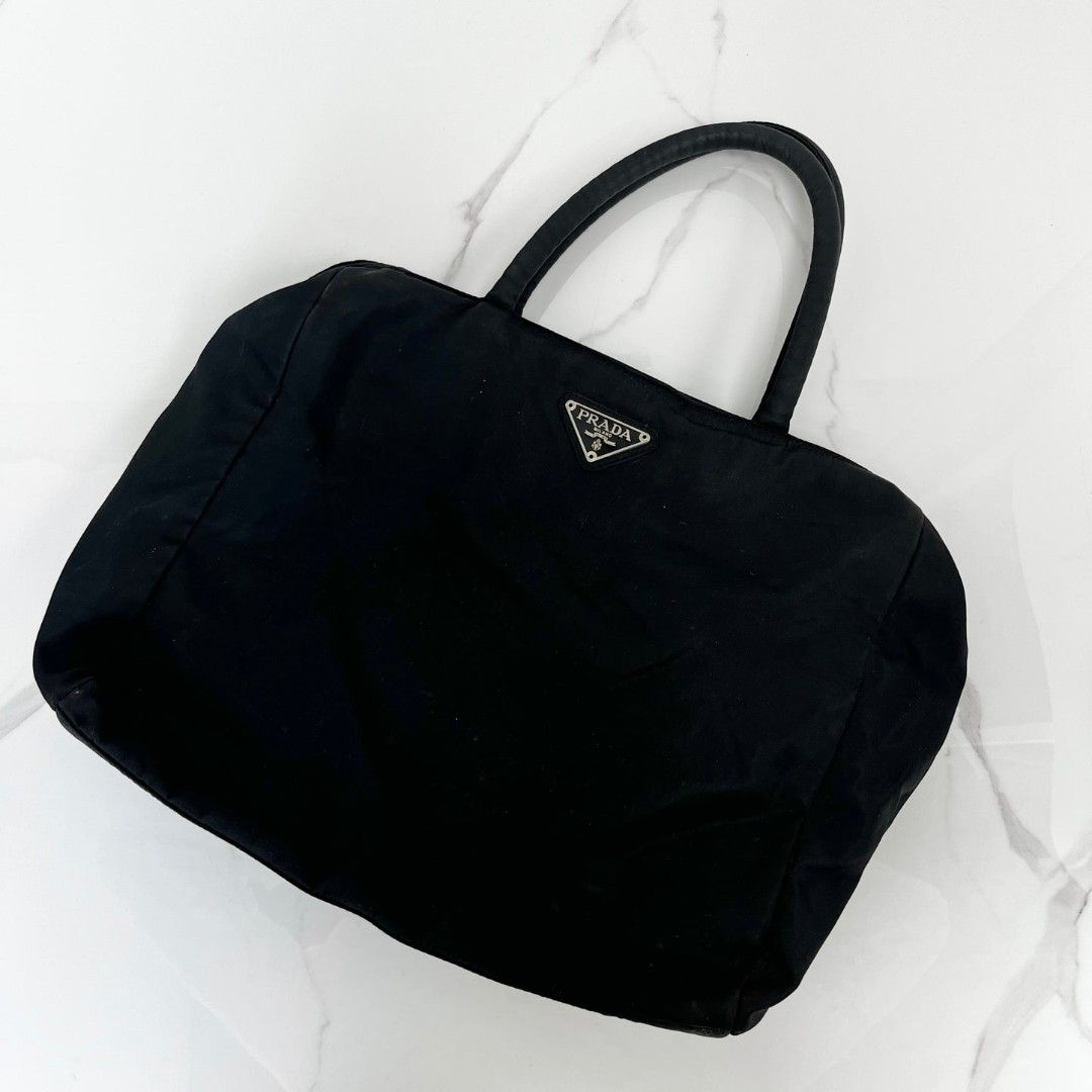 Prada Vintage Black Nylon Tote Bag (Category: Luxury Bags & Wallets) located in Makati City. Submitted by mrsdm (Listing ID 1444341365, Image 1). Description: - Classic black Prada nylon tote - Simple and functional design - Great for everyday use - Plenty of interior space - Comfortable handles - Versatile and matches any outfit.