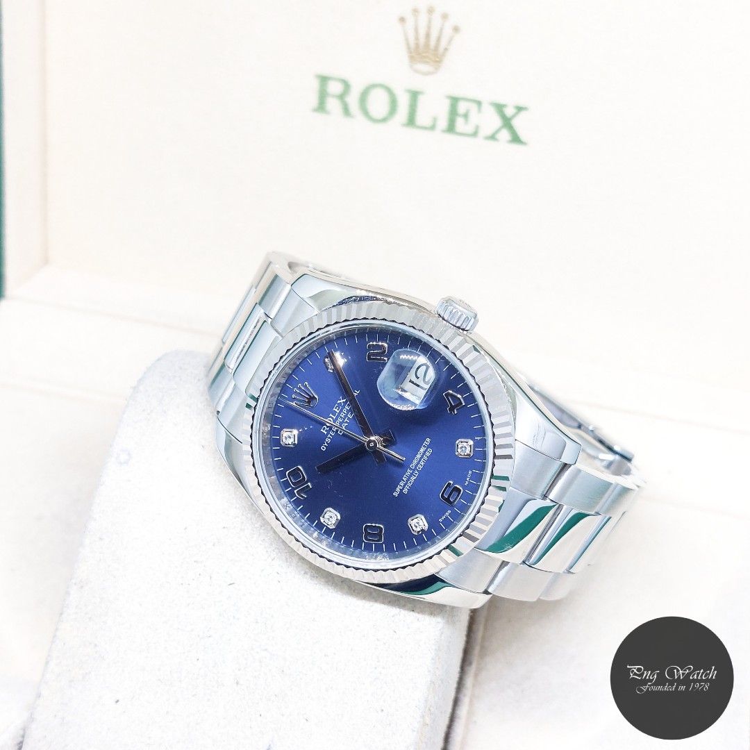 Rolex 34mm Blue Diamonds Dial Oyster Perpetual Date REF: 115234 (Z Series) (Category: Watches) located in Singapore. Submitted by pngwatchdealer (Listing ID 1444473948, Image 1). Description: [SPECIFICATIONS] **Watch comes with a generic pouch** **Straight bracelet** **Rehaut ring** Brand: Rolex Model: Oyster Perpetual Date 34mm Blue Diamonds Dial (REF: 115234)(Z) Movement: Automatic (Self-Winding) Functions and Features: Date, Hours, Minutes and