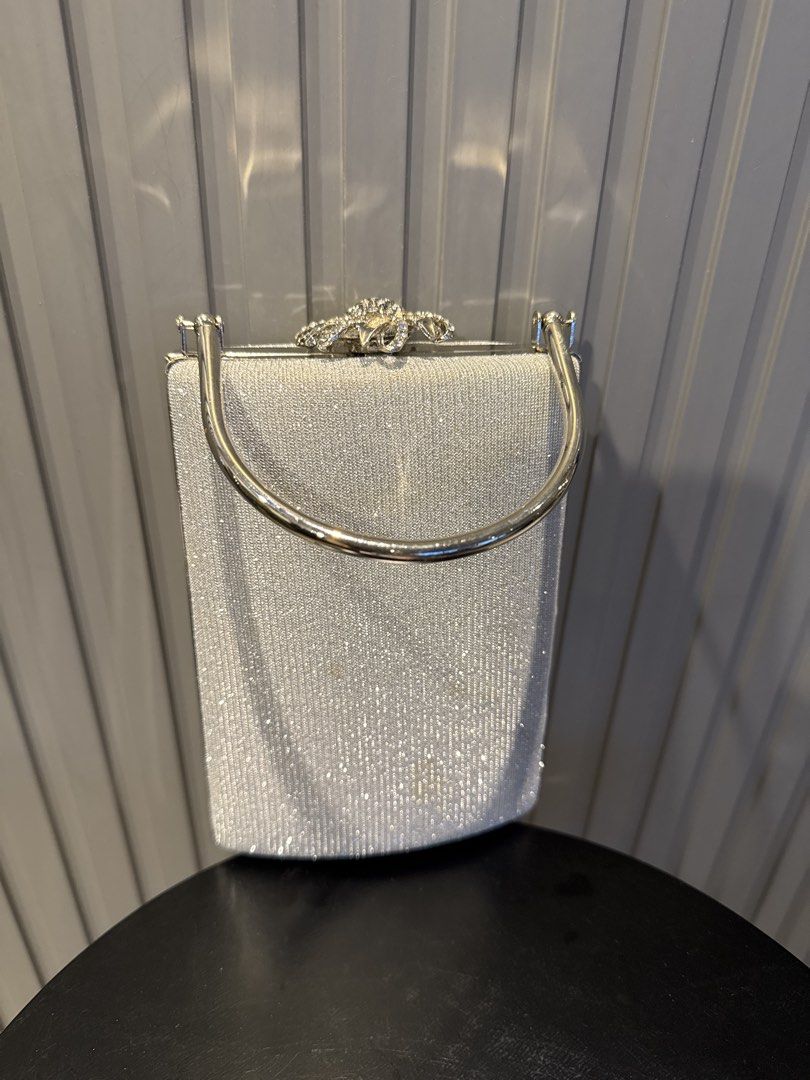 Sparkly Silver Beaded Clutch Bag with Rhinestone Clasp (Category: Clutches) located in Taguig. Submitted by tp2024 (Listing ID 1444411171, Image 1). Description: - Cute sparkly silver beaded clutch - Features a silver handle - Secure rhinestone clasp closure - Ideal for parties or special occasions - Small and compact size - Dimensions: Approximately 6 inches wide x 5 inches tall.