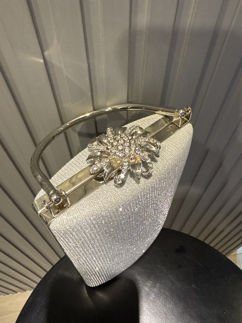Sparkly Silver Beaded Clutch Bag with Rhinestone Clasp (Category: Clutches) located in Taguig. Submitted by tp2024 (Listing ID 1444411171, Image 2). Description: - Cute sparkly silver beaded clutch - Features a silver handle - Secure rhinestone clasp closure - Ideal for parties or special occasions - Small and compact size - Dimensions: Approximately 6 inches wide x 5 inches tall.