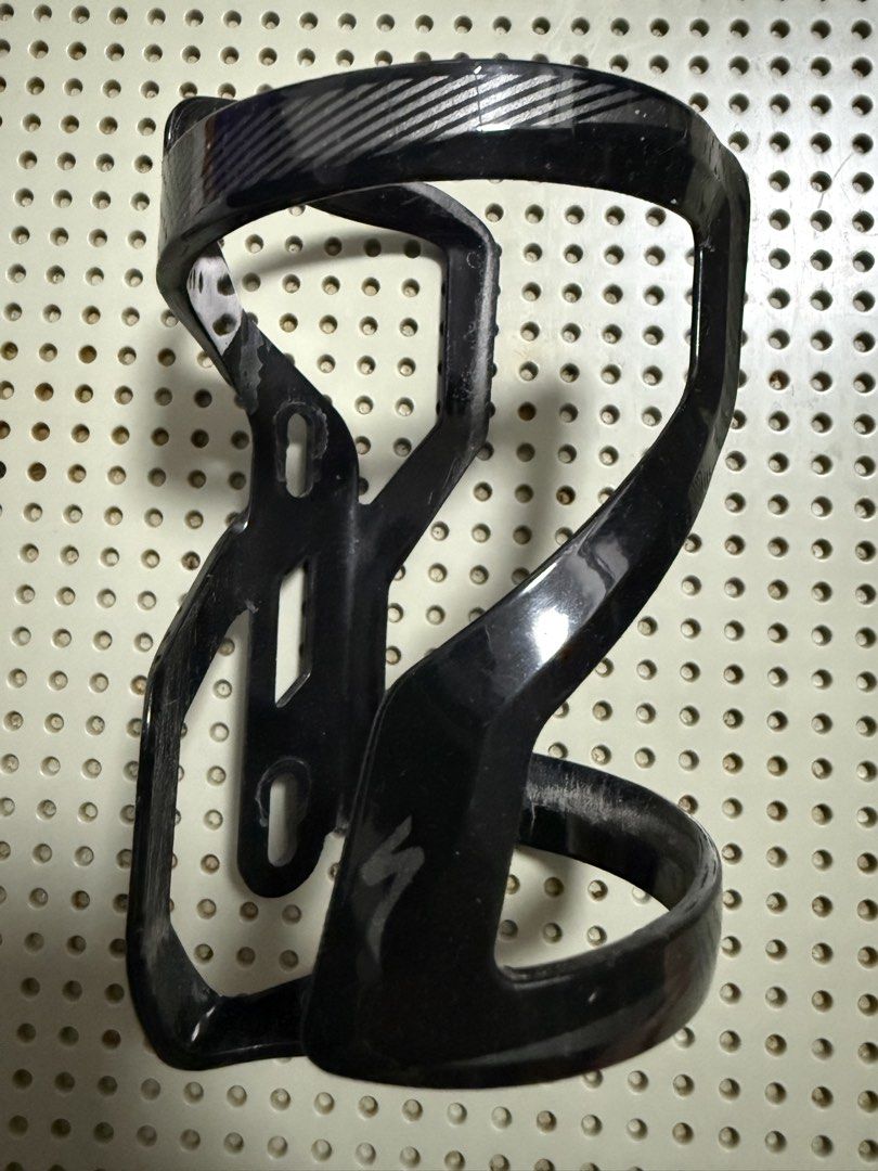 Specialized Black Bike Water Bottle Cage (Category: Parts & Accessories) located in Singapore. Submitted by sky_chester (Listing ID 1444343373, Image 1). Description: - Used black Specialized water bottle cage - Silver accents - Still holds bottles securely - Suitable for road bikes and mountain bikes.