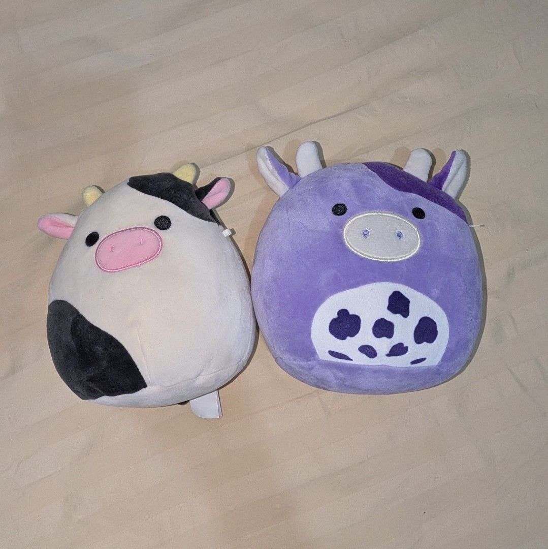 Squishmallow Cows - Black & White and Purple (Category: Plushies & Soft Toys) located in Imus. Submitted by buyingacc.exe (Listing ID 1444467066, Image 1). Description: black and white- 700 purple - 300 (not authentic, didn't come with tags) bundle: 900 rfs: too many plushies na shipping from: Imus, Cavite.