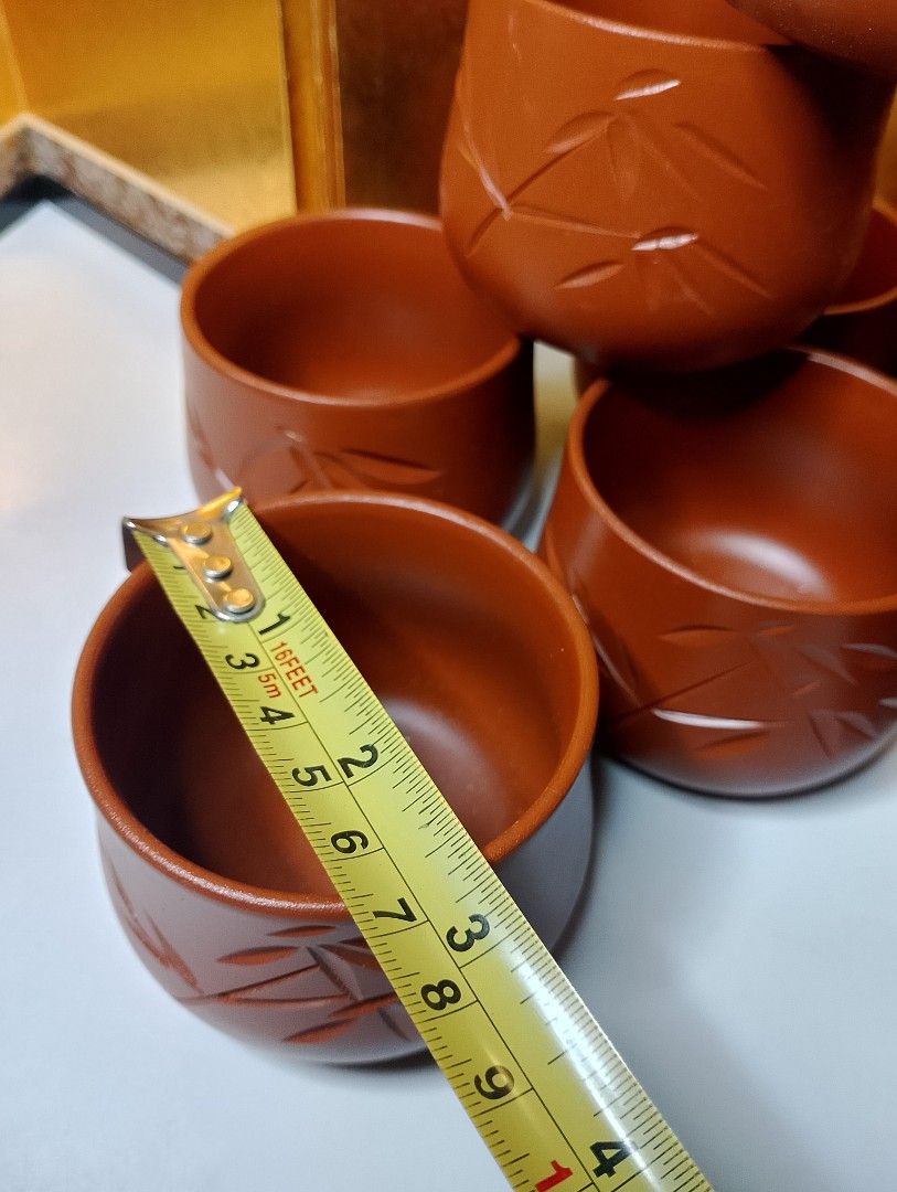 Terracotta Tea Cups with Bamboo Design (Category: Coffee & Tea Tableware) located in Valenzuela. Submitted by buylaaaaa (Listing ID 1444450042, Image 3). Description: - Set of 9 brown tea cups - Features a beautiful carved bamboo leaf design - Ideal size for tea or sake - Warm, earthy brown color - Perfect for serving guests or personal use - Stacks neatly for convenient storage - Feel free to ask any questions!.