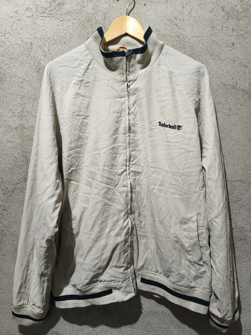Timberland Weathergear Jacket XL Beige (Category: Coats, Jackets and Outerwear) located in Cagayan de Oro. Submitted by thrift-japanuksurplus (Listing ID 1444369761, Image 2). Description: - Timberland Weathergear Jacket - Color: Beige - Size: XL - Features embroidered Timberland logo on chest - Ribbed cuffs and hem with dark blue trim - Collar also features dark blue trim - Ideal for outdoor activities - No known issues or defects.