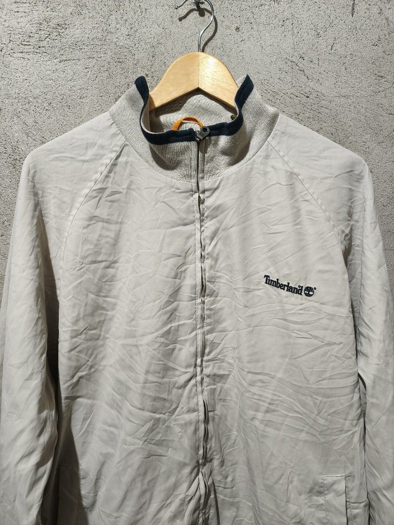 Timberland Weathergear Jacket XL Beige (Category: Coats, Jackets and Outerwear) located in Cagayan de Oro. Submitted by thrift-japanuksurplus (Listing ID 1444369761, Image 3). Description: - Timberland Weathergear Jacket - Color: Beige - Size: XL - Features embroidered Timberland logo on chest - Ribbed cuffs and hem with dark blue trim - Collar also features dark blue trim - Ideal for outdoor activities - No known issues or defects.