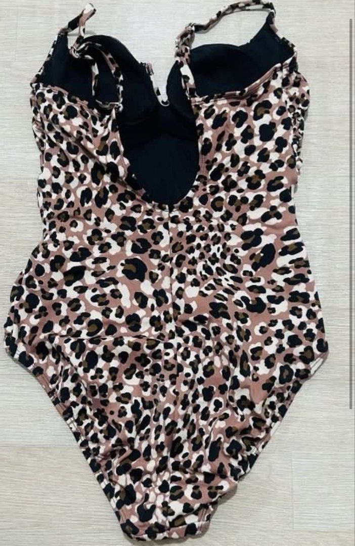 TIME and TRU Leopard Print One-Piece Swimsuit (Category: Bikinis & Swimsuits) located in Pasig City. Submitted by aiyee18 (Listing ID 1444357720, Image 2). Description: * Style: One-piece swimsuit * Print: Classic leopard/animal print in shades of blush pink, beige, brown, and black * Neckline: Deep V-neck with a small notch detail at the center front for an elegant touch * Straps: Adjustable spaghetti straps for a customizable fit * Waist Detail
