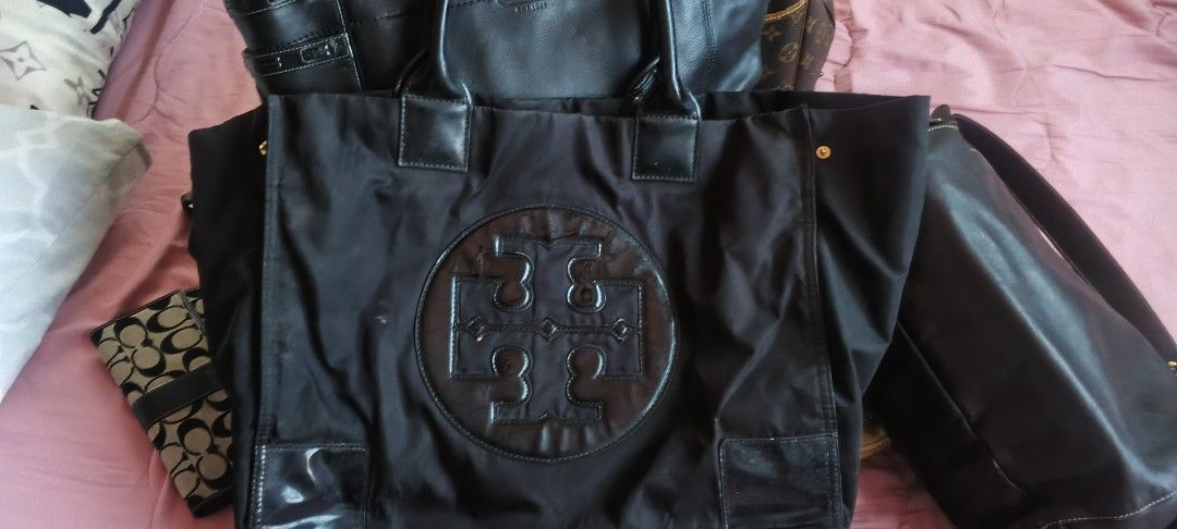 Tory Burch Black Nylon & Leather Tote Bag (Category: Luxury Bags & Wallets) located in Dasmarinas. Submitted by MVB0505 (Listing ID 1444332886, Image 3). Description: - Brand: Tory Burch - Color: Black - Material: Durable nylon with leather accents - Design: Iconic Tory Burch logo on the front - Interior: Multiple pockets for excellent organization - Hardware: Elegant gold details - Versatile: Ideal for everyday use or travel....