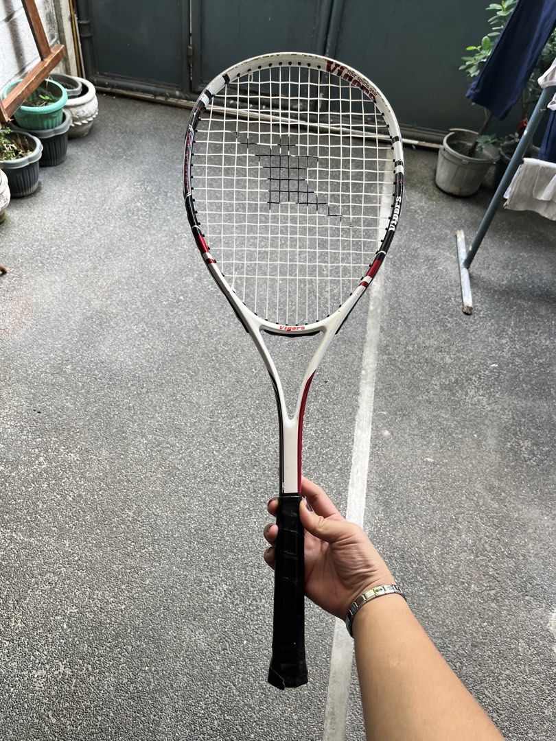 Vigors Tennis Racket AFFORDABLE (Category: Racket and Ball Sports) located in Quezon City. Submitted by nanithefawk (Listing ID 1444320538, Image 1). Description: - Vigors tennis racket - Color: White with red and black accents - Grip: Black - Condition: Some scuff marks on the frame, strings are intact - Ideal for: Casual play and beginners - rfs: barely used .