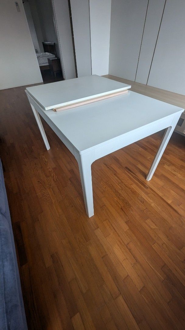 White Extendable Study Table (Category: Tables & Sets) located in Singapore. Submitted by viewtwooffer (Listing ID 1444329235, Image 2). Description: - Extendable white study table - Visible wood grain detail - Ideal for small spaces or when hosting guests - Easy to clean surface.