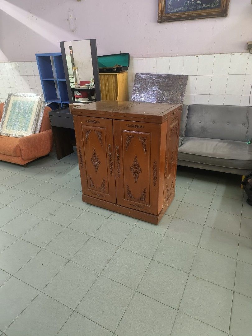 Wooden Bar Cabinet with Wine Rack and Storage (Category: Shelves, Cabinets & Racks) located in Johor Bahru. Submitted by borneobundle4 (Listing ID 1444345595, Image 2). Description: - kayu jati - Central wine rack - Ample side storage shelves - Includes a small drawer - Ideal for entertaining or home bar setup - Doors open fully for easy access - Features a warm, inviting wood tone.
