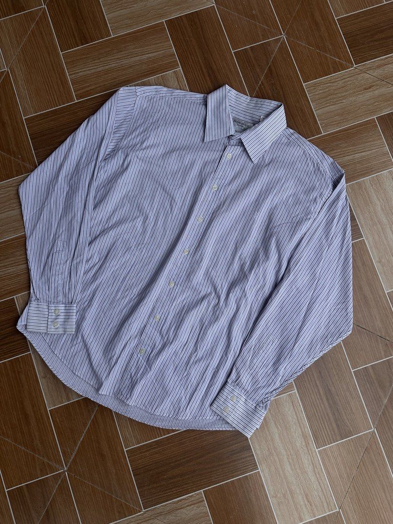 Yves Saint Laurent Men's (Category: Luxury Apparel) located in Davao. Submitted by kurttyyo (Listing ID 1444389173, Image 1). Description: - Classic Yves Saint Laurent dress shirt - Fine blue and maroon pinstripes on white - 100% cotton for ultimate comfort - Long sleeves with button cuffs - Button-down front - Small embroidered YSL logo on chest - Ideal for formal events or smart-casual styling YSL XL | 27.5 x 31f 32b Excellent 1,200.