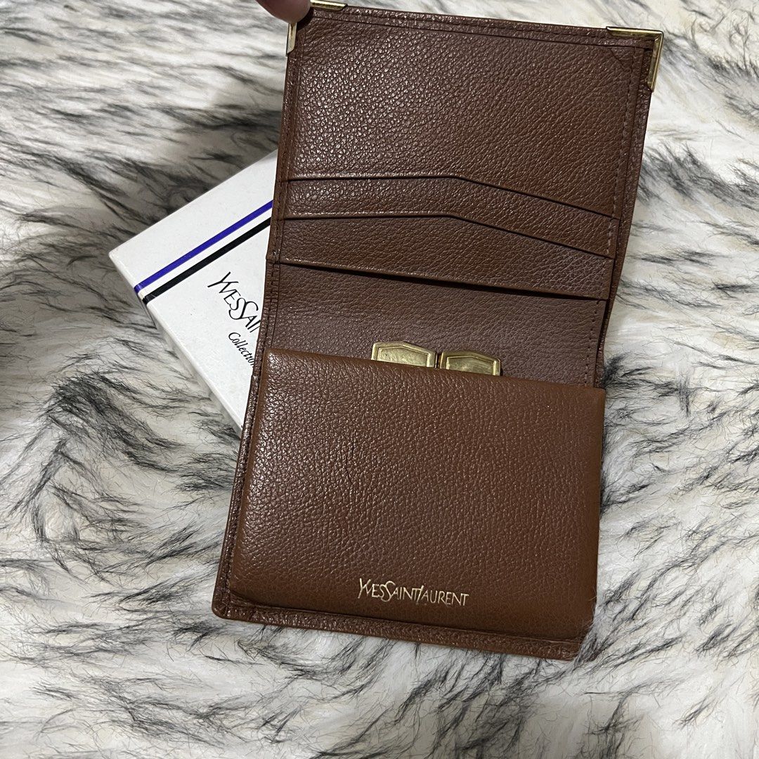 YSL Leather Bifold Wallet (Category: Luxury Bags & Wallets) located in Davao. Submitted by justin_sells (Listing ID 1444398145, Image 2). Description: Vintage YSL Bifold Wallet -leather goods -preloved, good condi - Features a secure coin purse with a clasp closure. - Elegant gold hardware details on corners and clasp. - Comes with the original YSL box. - Timeless and classic YSL design..