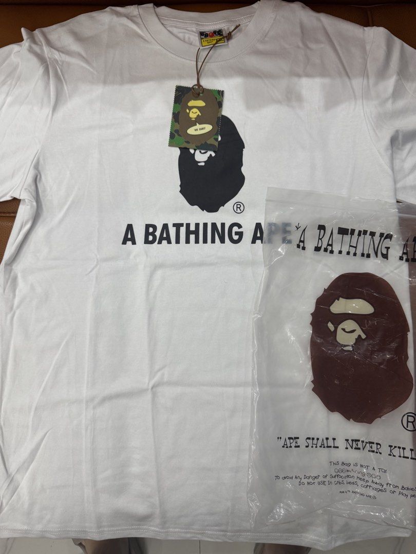A Bathing Ape BAPE T-Shirt White (Category: Tshirts & Polo Shirts ) located in Manila. Submitted by mitchellzeng (Listing ID 1444501367, Image 2). Description: - Classic white BAPE t-shirt - Features iconic ape head graphic - Includes "A BATHING APE" text - Comes with original tags and packaging - Ideal for streetwear fans.