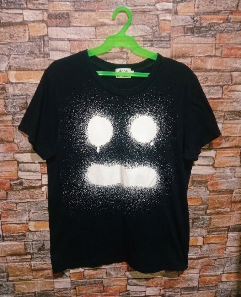 Acne Studios Graphic Sad face T-shirt ( size large to XL) (Category: Tshirts & Polo Shirts ) located in Manila. Submitted by liz_gatz (Listing ID 1444670620, Image 2). Description: - Brand: Acne Studios - Color: Black - Size: XL - 21.5 x 28 - Design: Iconic spray paint face graphic - Condition: Good, lightly used - Style: Casual, pairs well with jeans.