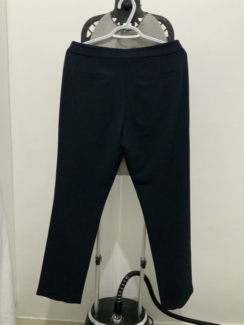 Apple & Eve Black Navy Blue Trousers (Category: Other Bottoms) located in Taguig. Submitted by mstyphoon (Listing ID 1444536573, Image 3). Description: - Brand: Apple & Eve - Color: Navy Blue - Size: L, Waist: 29-31 - Material: Rayon, Nylon, Spandex blend - Features: Pockets at front and back - Condition: Slight opening at the back seam (see last photo), already sewed - Style: Suitable for casual or work wear.