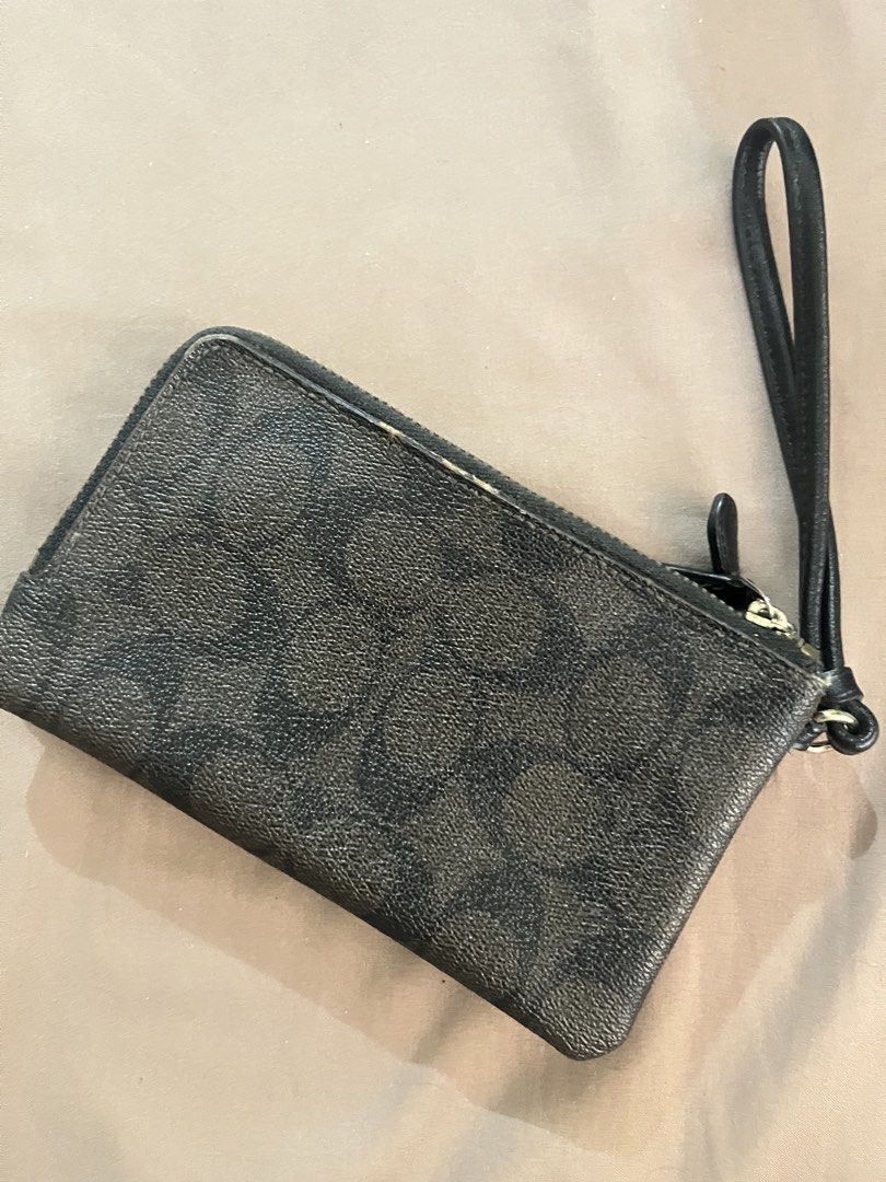 Auth Coach Signature Canvas Double Zip Wristlet Pouch (Category: Luxury Bags & Wallets) located in Manila. Submitted by subz013 (Listing ID 1444552735, Image 3). Description: Coach wristlet in signature C print - Color: Dark brown and black - Two zippered compartments - Wrist strap - Ideal for carrying cards, cash, and phone - Minor signs of wear on exterior - zippers are working, no issues Authentic, bought in the US.