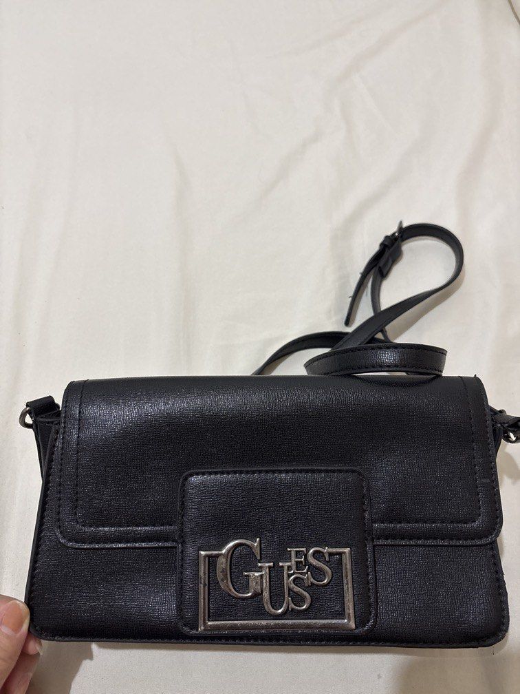 Authentic Guess cross-body bag in black (Category: Cross-body Bags) located in Balanga. Submitted by pmcgee (Listing ID 1444606590, Image 1). Description: See pics for flaws (only major flaw is the sling attachment but still usable) Authentic Guess.