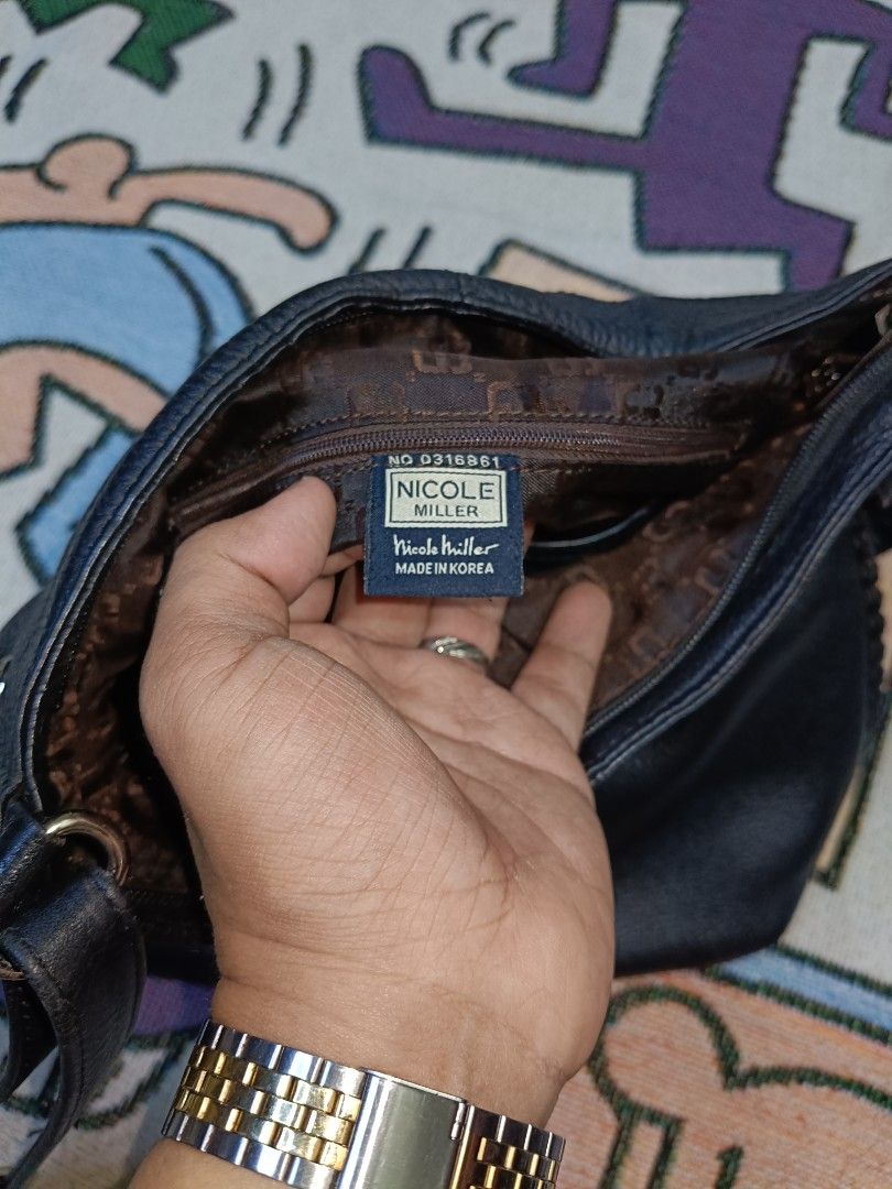 Authentic Nicole Miller Sling Bag (Category: Cross-body Bags) located in Taguig. Submitted by handpickedreplay (Listing ID 1444626060, Image 3). Description: Authentic Nicole Miller Sling Bag 👽 This is a guaranteed authentic nicole miller sling bag, coded as a proof of authenticity. The bag itself is made up of genuine leather as well as the tassel of the bag. This is excellent condition no major issue just minimal sign of usage, also the hardwa