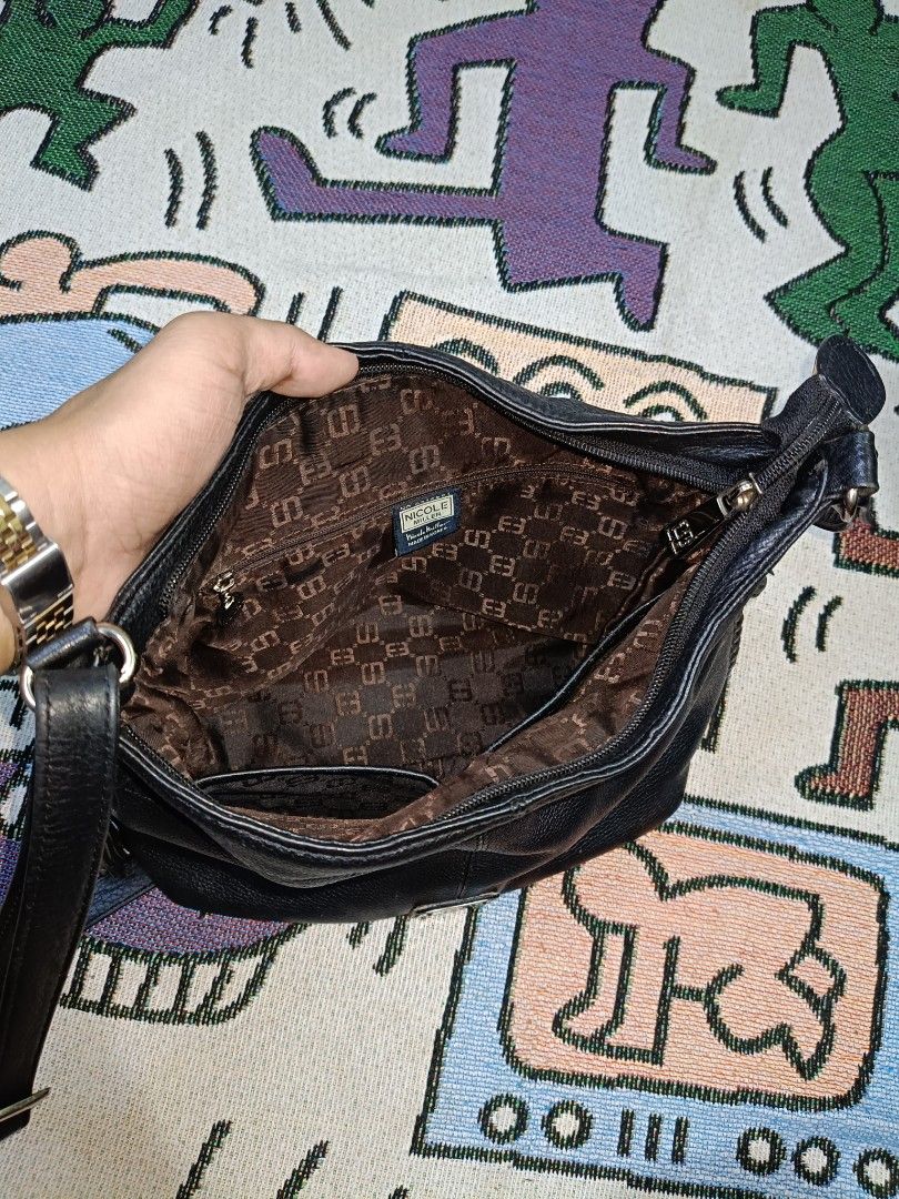 Authentic Nicole Miller Sling Bag (Category: Cross-body Bags) located in Taguig. Submitted by handpickedreplay (Listing ID 1444626060, Image 2). Description: Authentic Nicole Miller Sling Bag 👽 This is a guaranteed authentic nicole miller sling bag, coded as a proof of authenticity. The bag itself is made up of genuine leather as well as the tassel of the bag. This is excellent condition no major issue just minimal sign of usage, also the hardwa