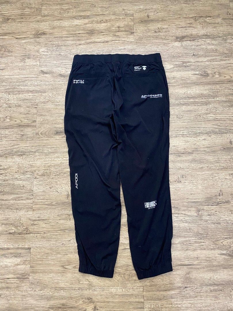 BAPE AP-201209 Black Track Pants (Category: Joggers) located in Cebu City. Submitted by francloset_1 (Listing ID 1444537709, Image 3). Description: - Authentic BAPE track pants - Features iconic ape head logo and "BAPE" text graphics - Comfortable elastic waistband with drawstring - Convenient zippered side pockets - Includes a back pocket detail - Ideal for casual outings or sports activities -Dimes W16 L 37.5 Ins 14 T12 H 6.