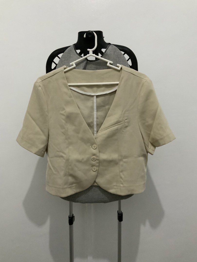 Beige Cropped Blazer with Short Sleeves (Category: Coats, Jackets and Outerwear) located in Taguig. Submitted by mstyphoon (Listing ID 1444537831, Image 1). Description: - Light beige cropped blazer - V-neckline - Three buttons down the front - Small pocket on left chest - Versatile for layering over tops or dresses.
