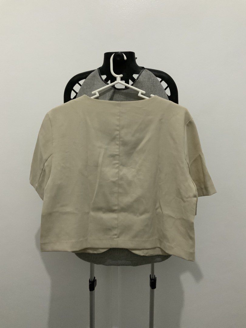 Beige Cropped Blazer with Short Sleeves (Category: Coats, Jackets and Outerwear) located in Taguig. Submitted by mstyphoon (Listing ID 1444537831, Image 3). Description: - Light beige cropped blazer - V-neckline - Three buttons down the front - Small pocket on left chest - Versatile for layering over tops or dresses.