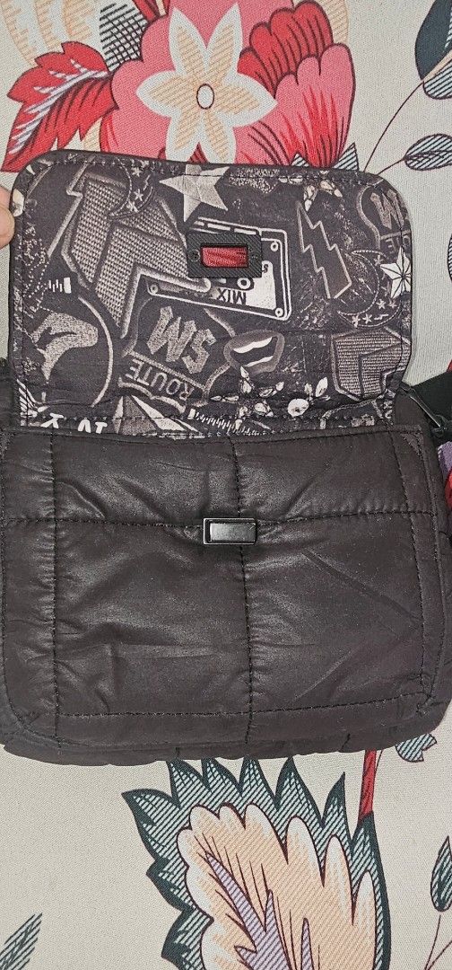 Black Quilted Crossbody Bag with Graphic Lining (Category: Cross-body Bags) located in Cainta. Submitted by cyjozuza (Listing ID 1444510819, Image 2). Description: - Stylish black quilted crossbody bag - Features a cool graphic print lining inside - Secure zipper closure - Adjustable strap for comfortable wear - Unique buckle detail on the front flap - Ideal for everyday use - Spacious enough for your essentials.