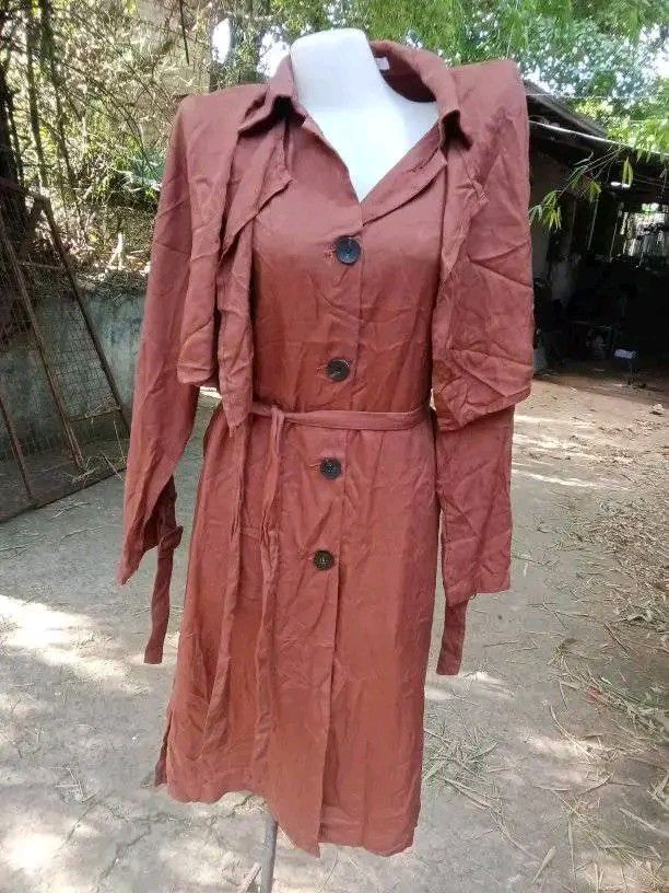 Brown Long Trench Coat with Belt (Category: Coats, Jackets and Outerwear) located in Cavite. Submitted by garinmaric11231 (Listing ID 1444511882, Image 2). Description: - Classic long brown trench coat - Features a belt to cinch the waist - Button closure down the front - Ideal for layering over outfits - Perfect for cooler weather.