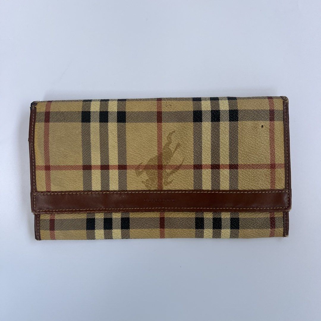 Burberry Vintage Nova Check Continental Wallet (Category: Luxury Bags & Wallets) located in Iloilo. Submitted by errrr0r (Listing ID 1444509548, Image 1). Description: features: • classic beige nova check coated canvas • brown leather trim and interior • long continental-style flap wallet • multiple card slots • interior zip compartment read!!! • can be cleaned or washed using wipes or any soft towel/brush • has a small hole on the outer right pa
