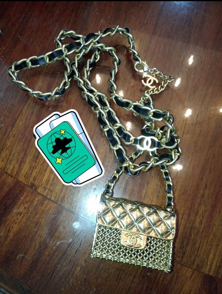Chanel Gold Chain Belt with Mini Bag Charm Authentic (Category: Luxury Accessories) located in Manila. Submitted by christoph17 (Listing ID 1444504710, Image 1). Description: - Authentic Chanel belt - Iconic CC logo - Mini quilted bag charm - Black leather woven through the chain - Clasp engraved 'Chanel Made in France' - Perfect statement piece - Ideal for collectors.