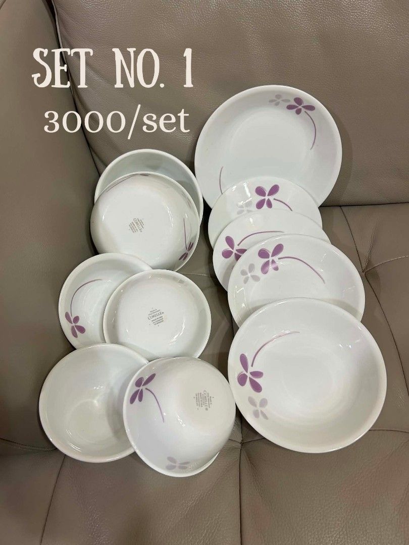 Corelle Dinnerware Sets - Various Designs Available (Category: Dinnerware & Cutlery) located in Cebu City. Submitted by mjuntilla (Listing ID 1444642255, Image 1). Description: Selling multiple sets of Corelle dinnerware. Each set has a unique design. Set 1 has purple flowers. Set 2 features pink daisies. Set 3 has blue berries. Set 4 displays green leaves. Set 6 showcases colorful dots. Great for everyday use or special occasions. Please check p