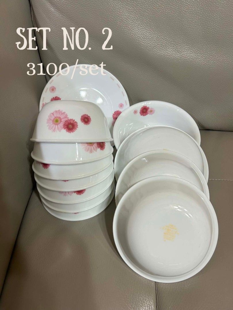 Corelle Dinnerware Sets - Various Designs Available (Category: Dinnerware & Cutlery) located in Cebu City. Submitted by mjuntilla (Listing ID 1444642255, Image 2). Description: Selling multiple sets of Corelle dinnerware. Each set has a unique design. Set 1 has purple flowers. Set 2 features pink daisies. Set 3 has blue berries. Set 4 displays green leaves. Set 6 showcases colorful dots. Great for everyday use or special occasions. Please check p