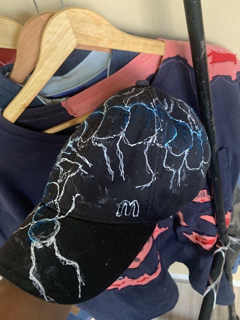 Custom Painted Black Baseball Cap with Scorpion design (Category: Caps & Hats) located in Manila. Submitted by exclusivethreads24 (Listing ID 1444516840, Image 2). Description: - Black baseball cap - Custom white and blue lightning bolt design - Hand-painted, unique look - Adjustable strap at the back for a comfortable fit - One size fits most - Perfect for adding an edgy style to your outfit.