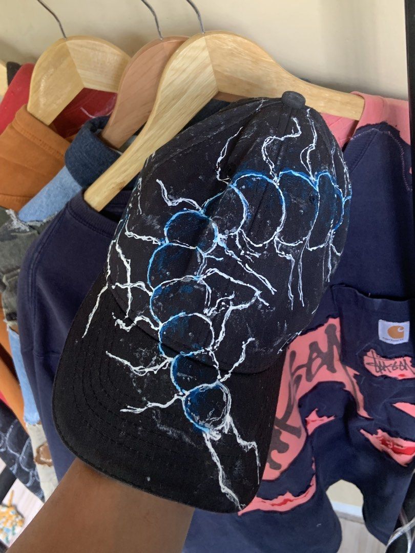 Custom Painted Black Baseball Cap with Scorpion design (Category: Caps & Hats) located in Manila. Submitted by exclusivethreads24 (Listing ID 1444516840, Image 1). Description: - Black baseball cap - Custom white and blue lightning bolt design - Hand-painted, unique look - Adjustable strap at the back for a comfortable fit - One size fits most - Perfect for adding an edgy style to your outfit.