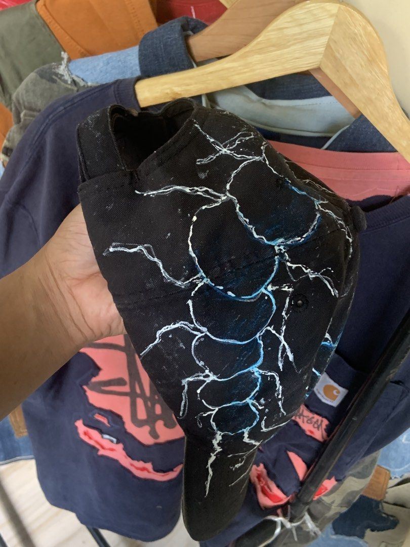 Custom Painted Black Baseball Cap with Scorpion design (Category: Caps & Hats) located in Manila. Submitted by exclusivethreads24 (Listing ID 1444516840, Image 3). Description: - Black baseball cap - Custom white and blue lightning bolt design - Hand-painted, unique look - Adjustable strap at the back for a comfortable fit - One size fits most - Perfect for adding an edgy style to your outfit.